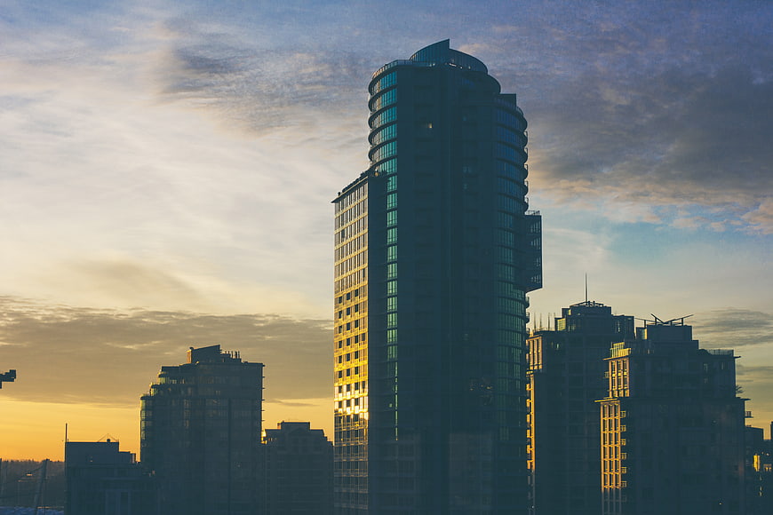 Modern Skyscrapers Silhouetted Against Golden Sunset Sky