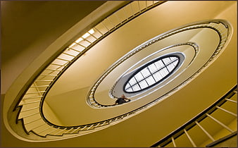 Low angle view of spiral staircase with man looking down