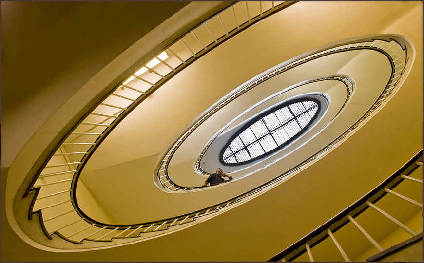 Low angle view of spiral staircase with man looking down