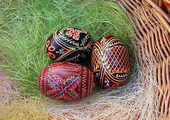 Traditional Easter Eggs in Wicker Basket with Grass
