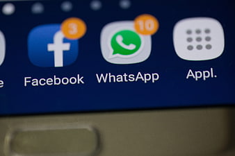 Close-up of Facebook and WhatsApp app icons on a smartphone screen