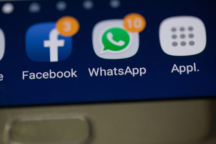 Close-up of Facebook and WhatsApp app icons on a smartphone screen