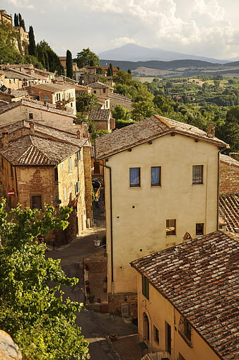 Sunlit Tuscan Village with Terracotta Roofs and Rolling Hills