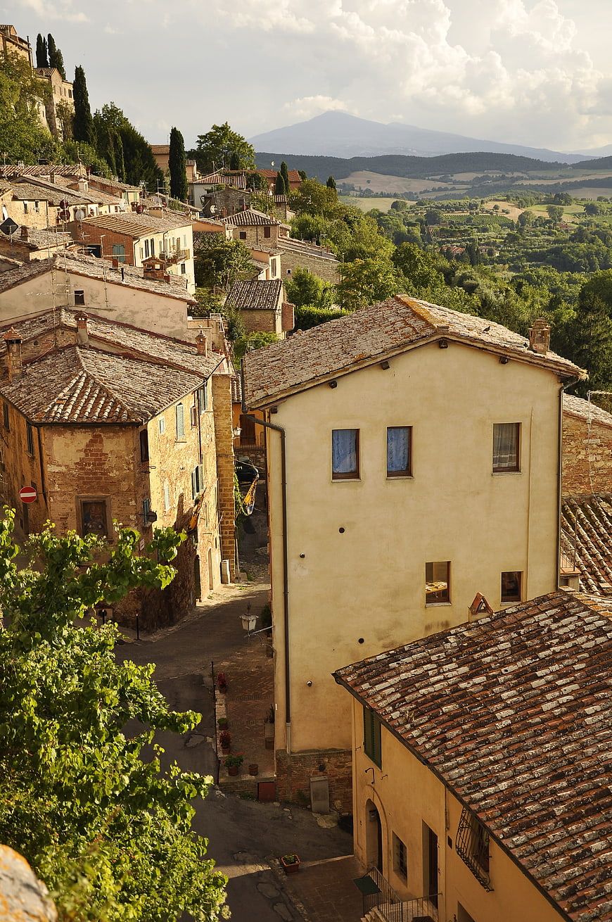 Sunlit Tuscan Village with Terracotta Roofs and Rolling Hills