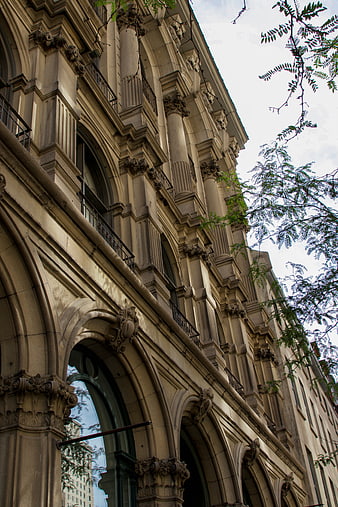 Low angle view of ornate classical building facade with arches