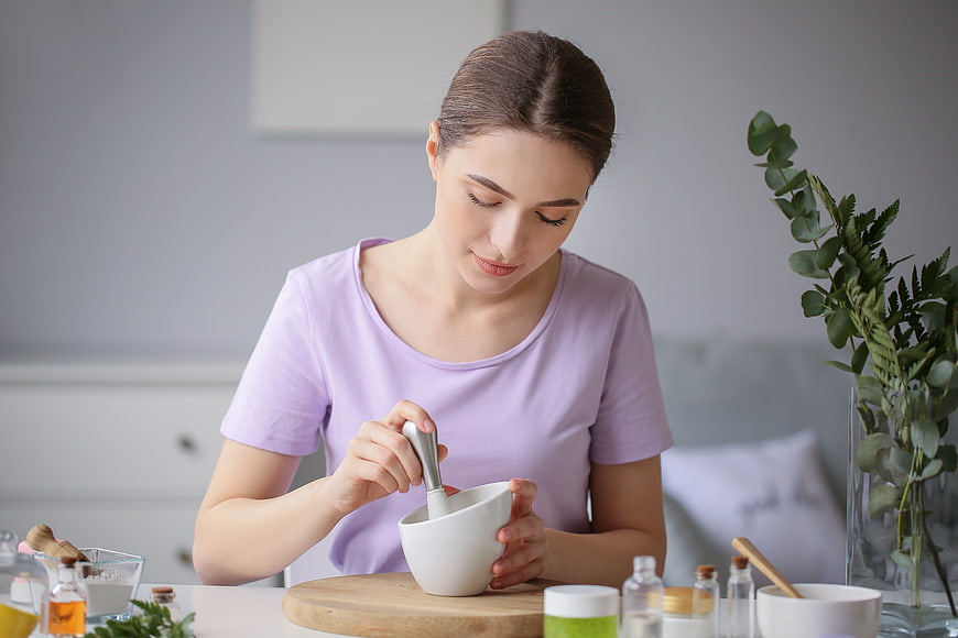 Woman making natural face mask with mortar and pestle
