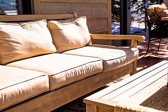 Wooden Outdoor Sofa with Beige Cushions on Deck