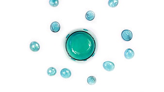 Top view of blue water drops and glass on white background