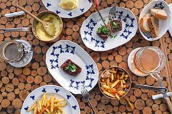 Top view of steak dinner with fries and beer on wooden table