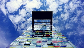 Low Angle View of Colorful Glass Skyscraper Against Blue Sky