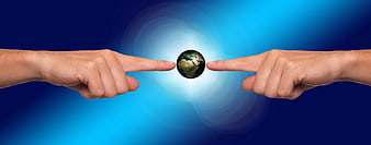 Two Hands Pointing at Small Globe on Blue Background