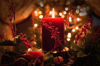 Red Christmas Candle with Berries and Bokeh Lights