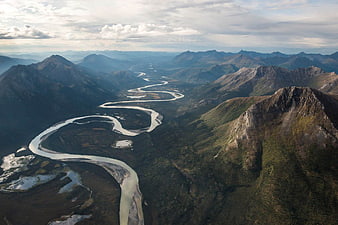 Aerial View of Winding River Through Mountain Valley