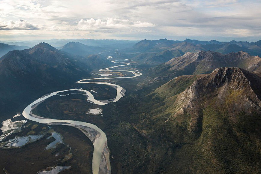 Aerial View of Winding River Through Mountain Valley