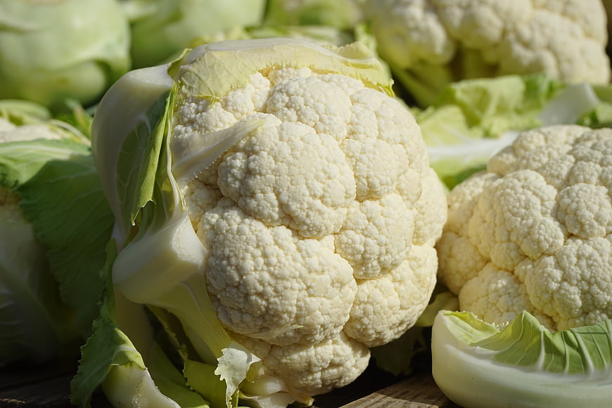 Fresh White Cauliflower Heads on Wooden Surface