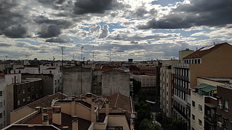 Dramatic cloudy sky over European city rooftops
