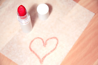 Red lipstick with heart drawn on tissue paper