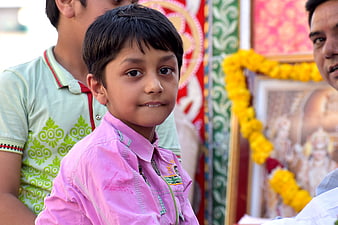 Cute young boy in pink shirt at cultural festival