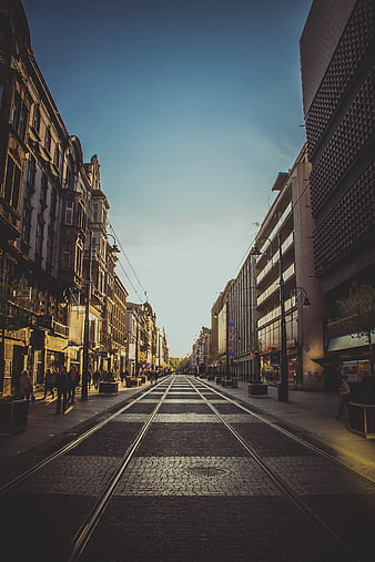 Urban street with tram tracks and pedestrians in city center