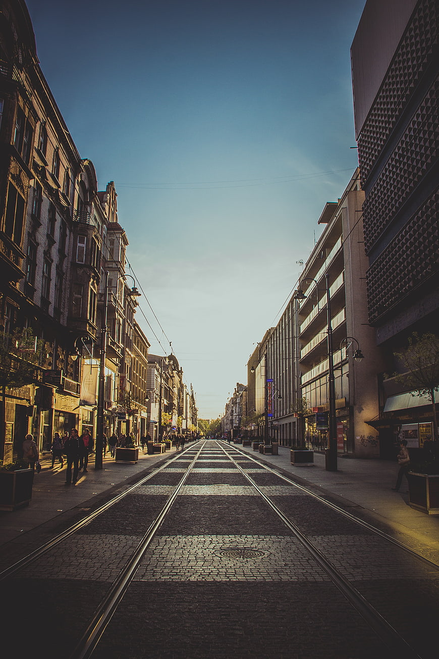 Urban street with tram tracks and pedestrians in city center