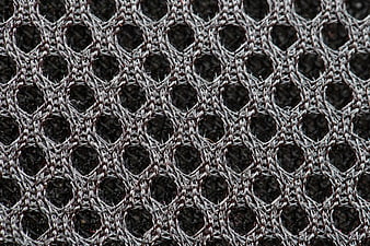 Close-up of textured gray woven fabric with circular pattern