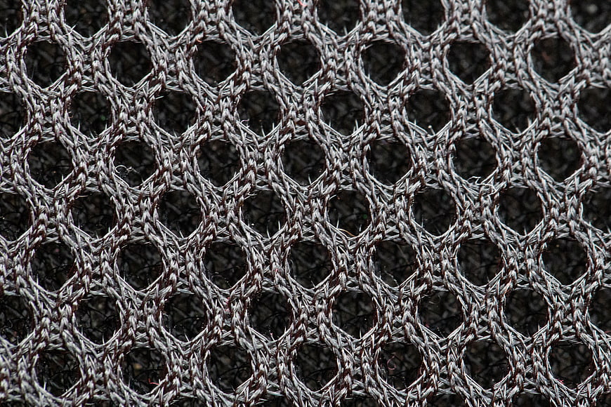 Close-up of textured gray woven fabric with circular pattern