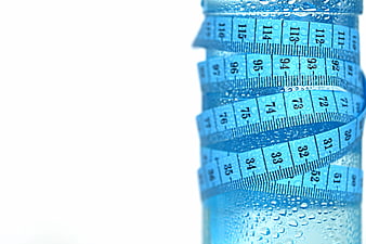 Blue measuring tape wrapped around a water bottle with condensation