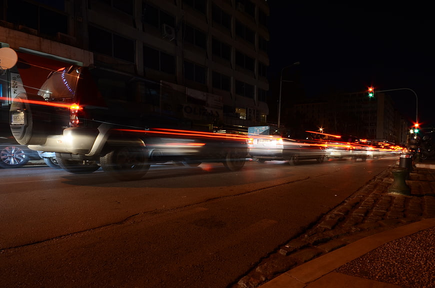 Night traffic with red light trails on city street