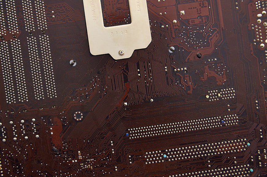 Close-up of brown computer motherboard circuit board