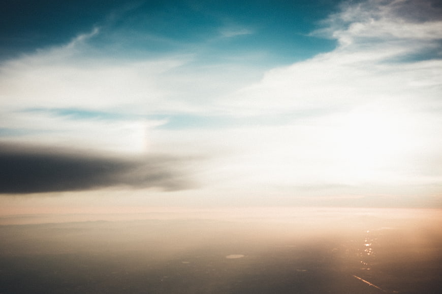 Aerial View of Clouds Over Ocean at Sunset
