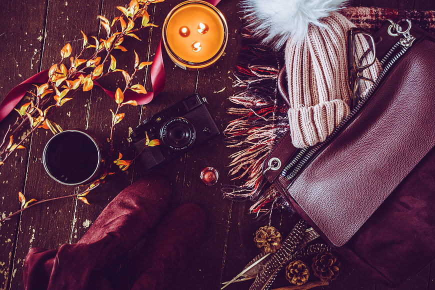 Autumn flat lay with vintage camera, candle, and accessories