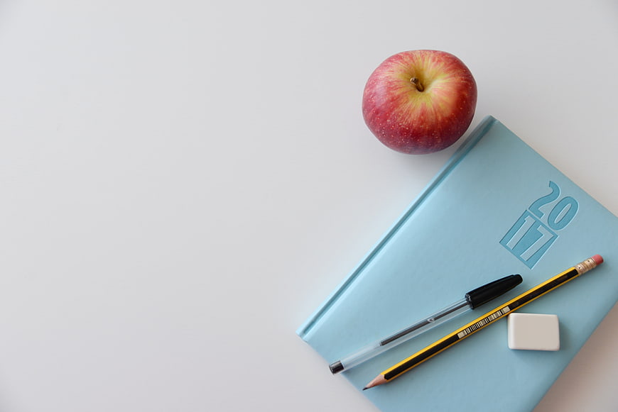 Blue 2017 Planner, Apple, and Stationery on White Background