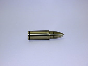 Single brass rifle cartridge on white background