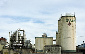 Industrial Factory Plant with Large Storage Silos and Pipes