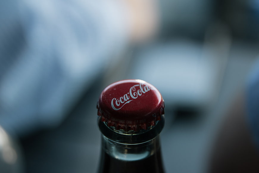 Close-up of a Coca-Cola bottle cap with blurred background
