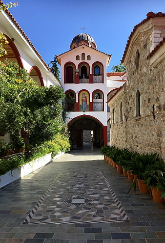 Greek Orthodox Monastery Courtyard with Stone Path and Bell Tower