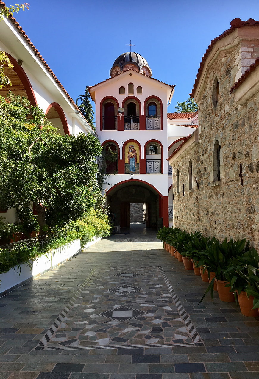 Greek Orthodox Monastery Courtyard with Stone Path and Bell Tower
