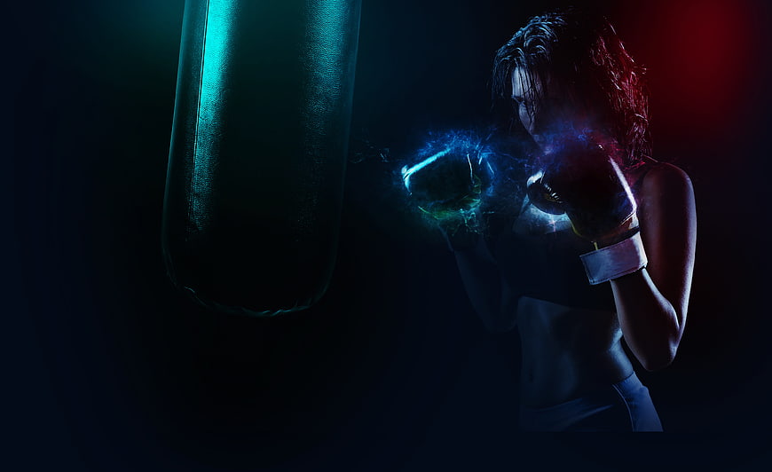 Female boxer training with dramatic neon lighting and smoke effects