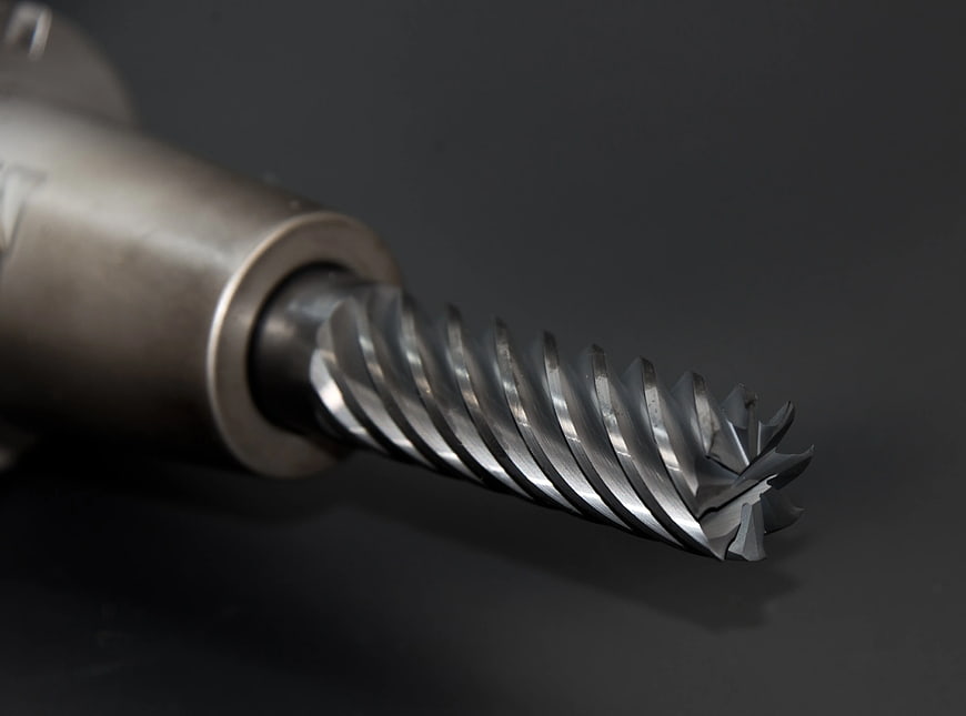 Close-up of Metal Twist Drill Bit on Dark Gray Background