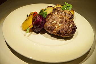 Grilled Steak with Roasted Vegetables on White Plate