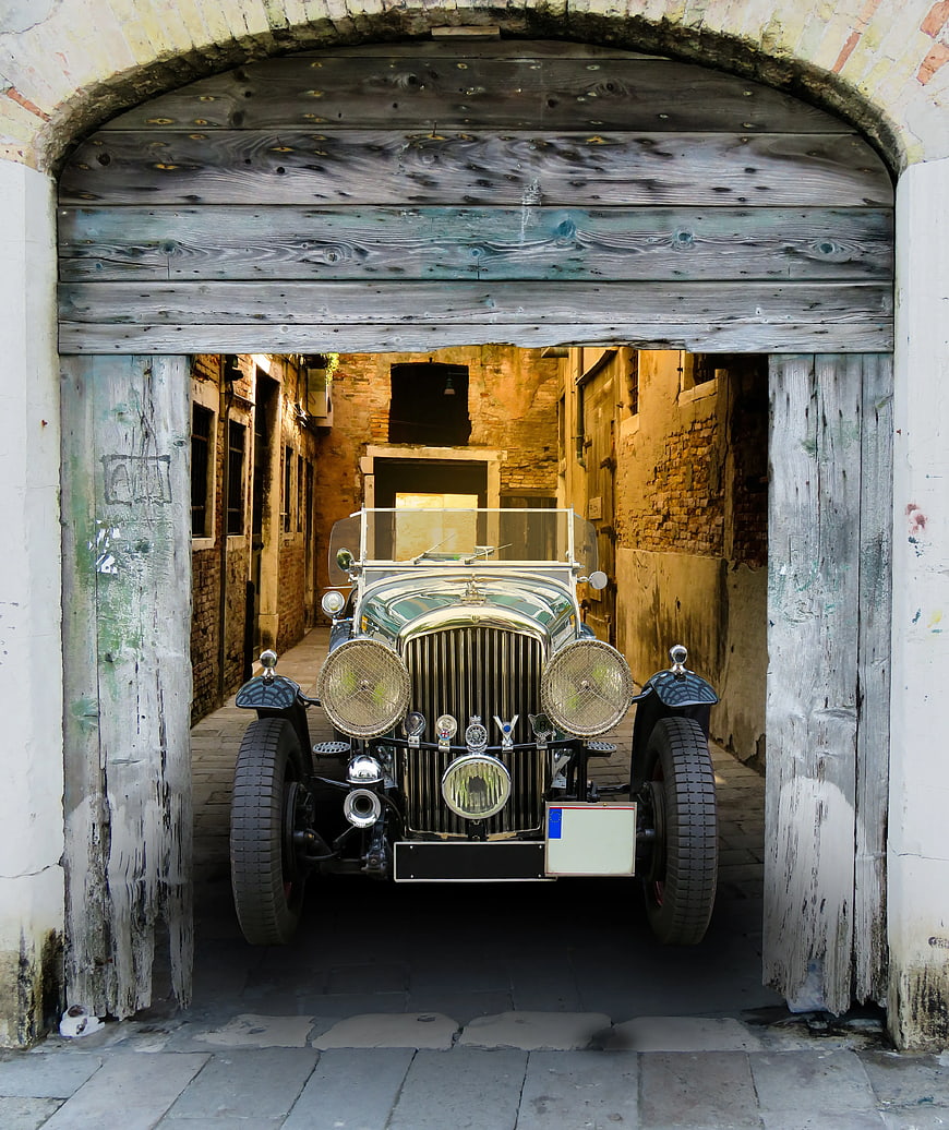Vintage Grey Car in Rustic Wooden Garage