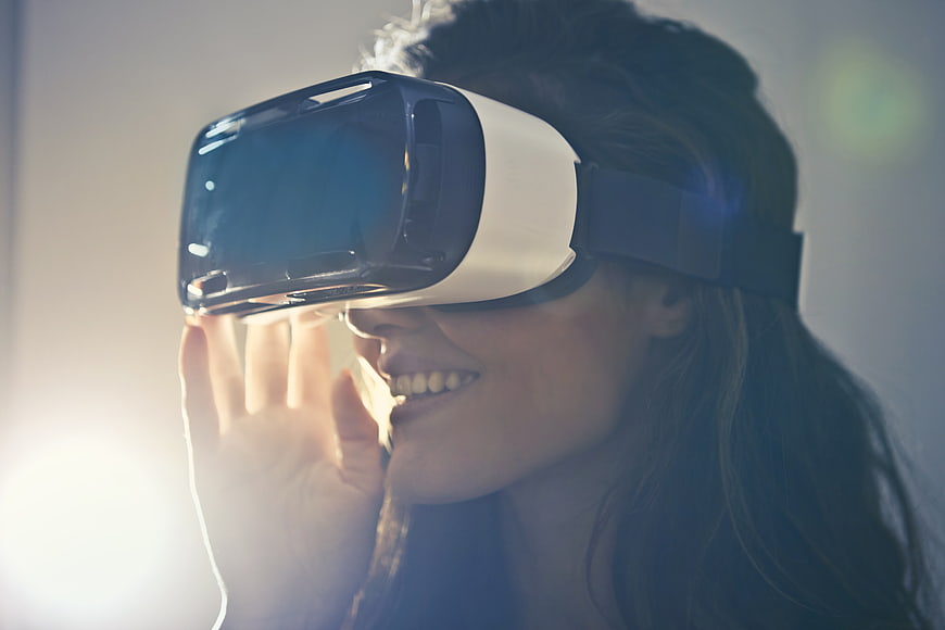 Happy Woman Wearing VR Headset with Lens Flare