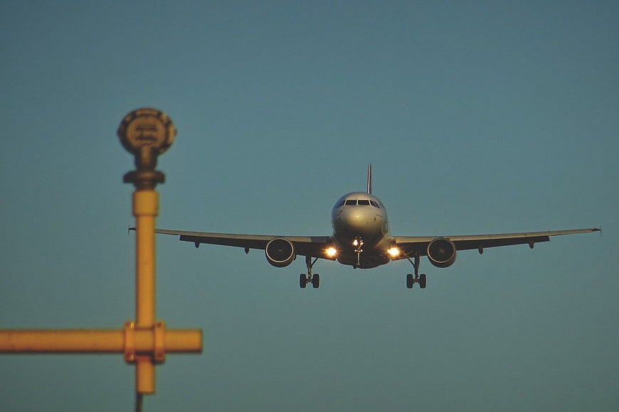 Commercial Airplane Landing at Airport with Runway Light