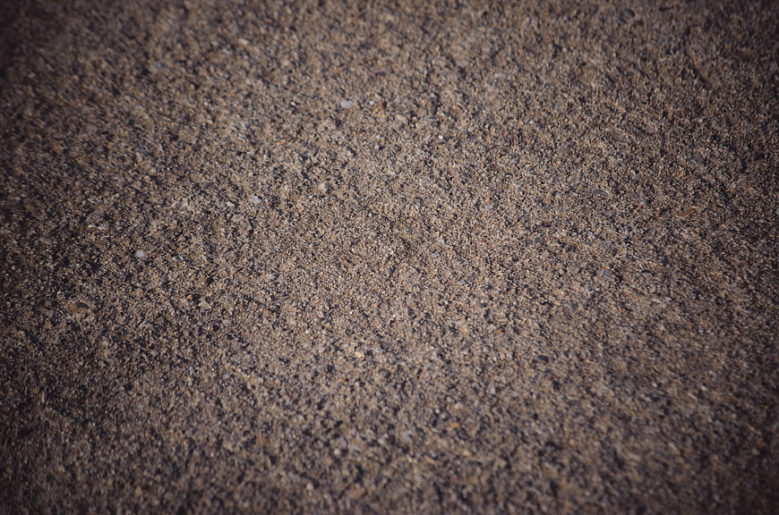 Close-up texture of dry cracked earth and gravel ground surface