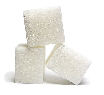 Three white sugar cubes stacked on a clean white background