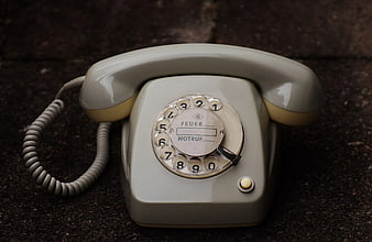 Vintage Gray Rotary Dial Telephone on Dark Surface