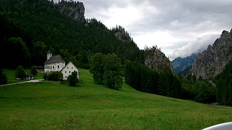 White Church in Green Alpine Valley with Mountains