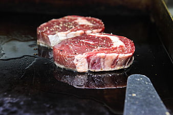 Raw Seasoned Filet Mignon Steaks Searing on Griddle