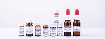 Assorted Homeopathic Medicine Bottles on White Background