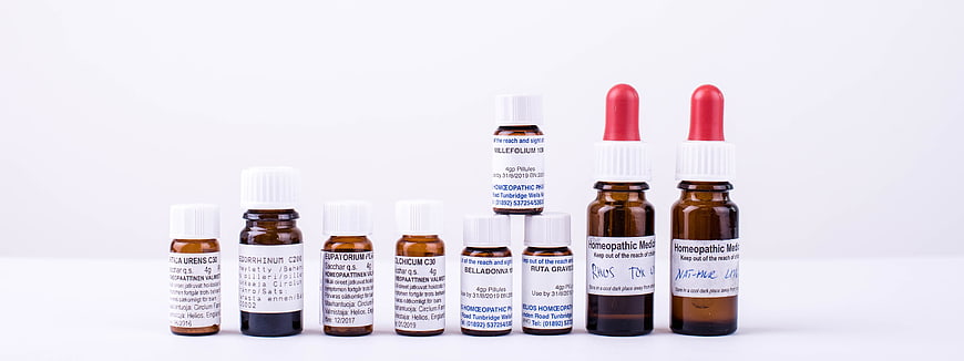 Assorted Homeopathic Medicine Bottles on White Background
